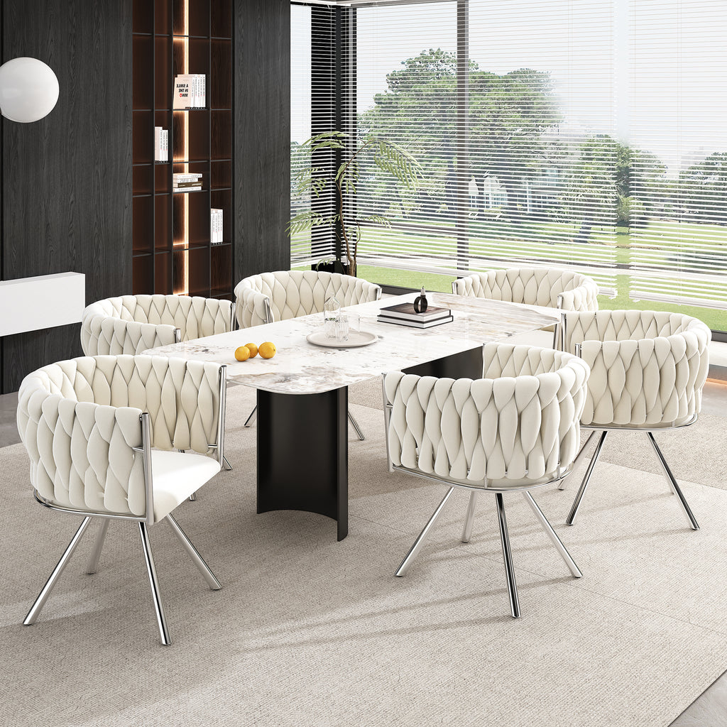 Modern dining room with a round table and tufted chairs in a well-lit room.