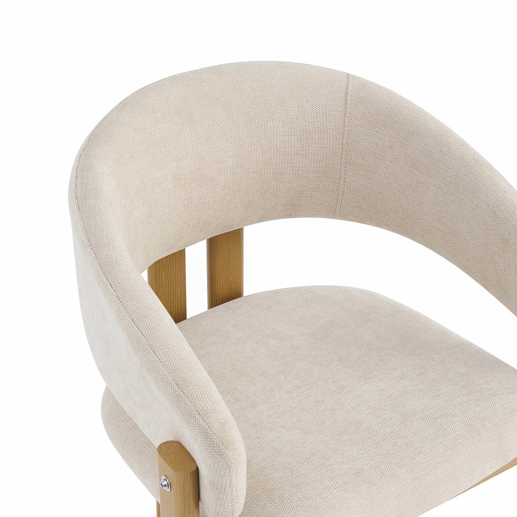 Close-up of a modern upholstered chair with a curved backrest and seat in a light beige textured fabric, supported by light natural wood legs, on a white background.