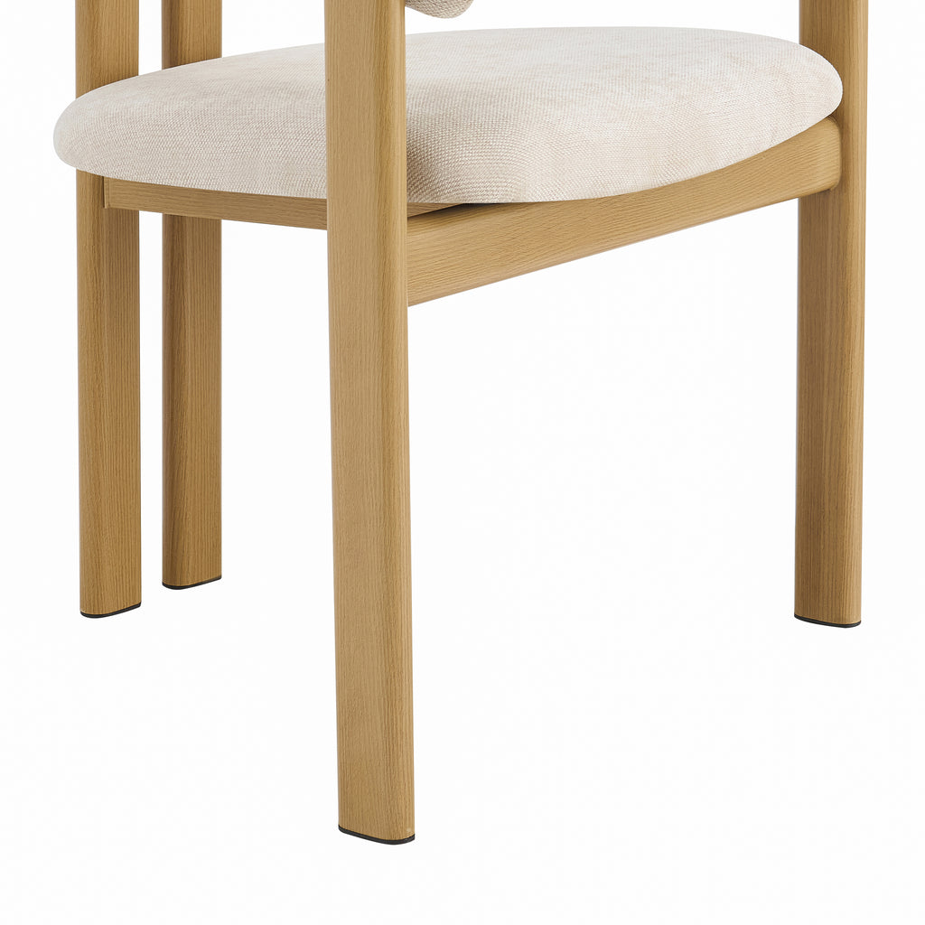 Close-up of a dining chair showing a light beige upholstered seat cushion and natural oak wood legs and frame on a white background.