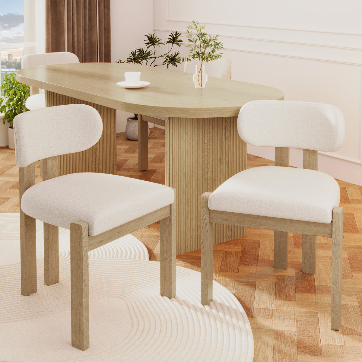 Dining table with four chairs in a bright room with plants