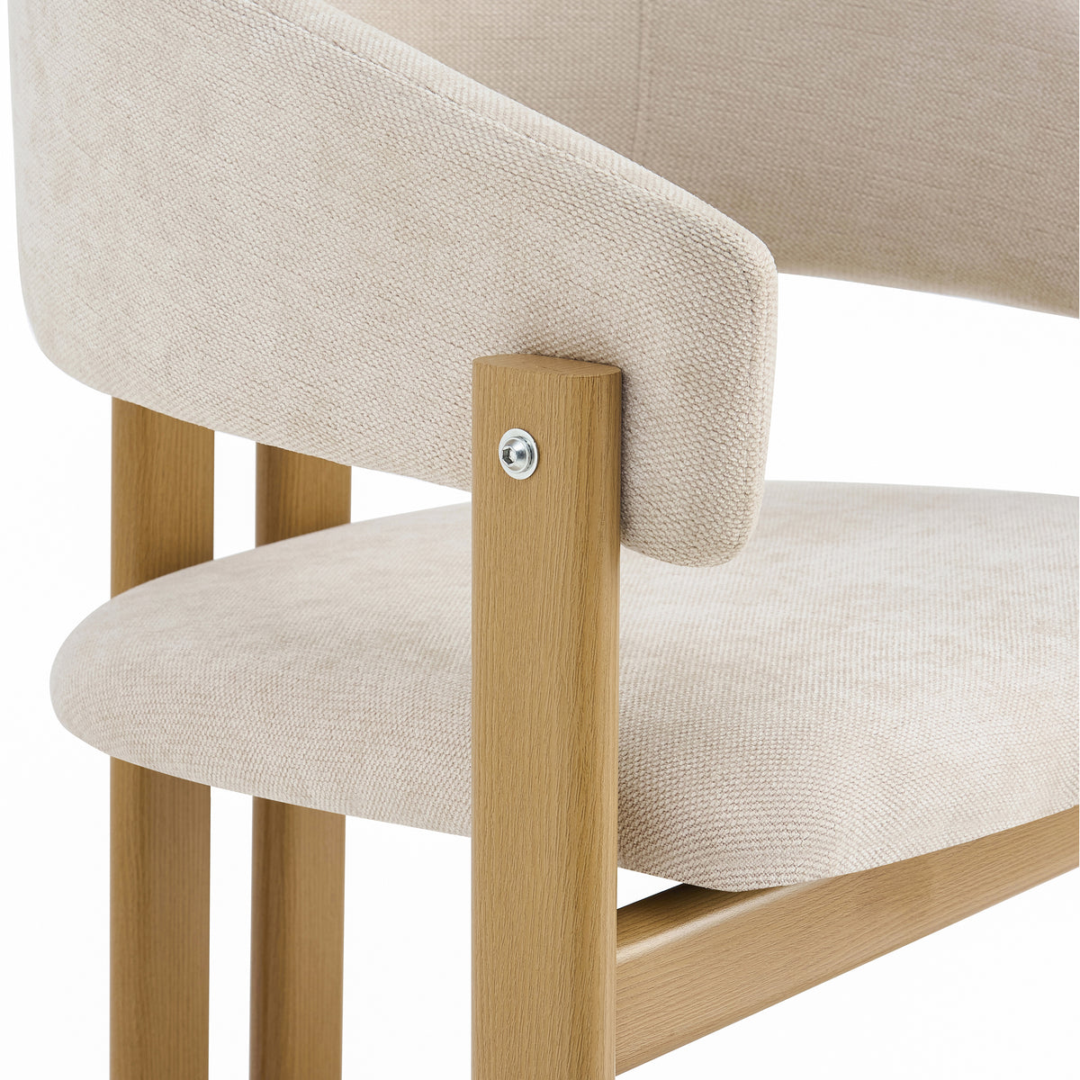 Close-up of a dining chair showing the beige textured fabric upholstery of the seat and curved backrest, attached to a light natural wood frame with a visible silver screw.