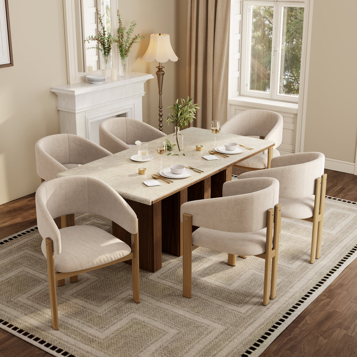 A dining set consisting of a rectangular wooden table with a light stone top and six upholstered armchairs with light beige fabric and natural wood frames, arranged on a patterned rug in a bright, modern dining room.